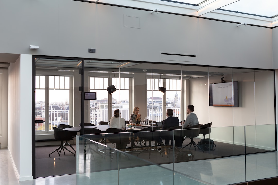 A team in an all glass window office discusses implementing successful account planning